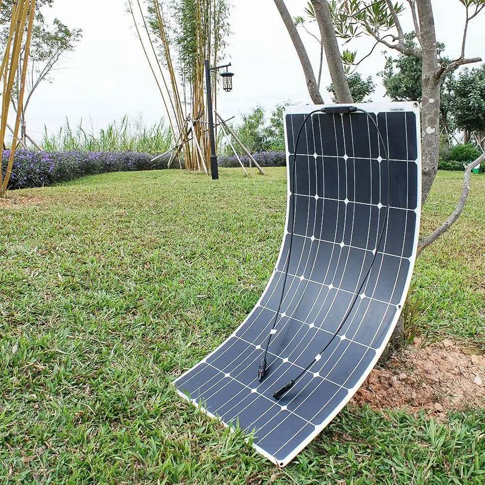 a solar panel laying on top of a lush green field